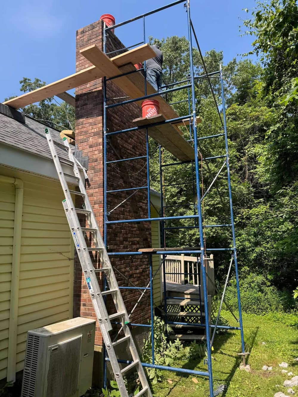 Brick chimney rebuild on a Central Connecticut home with matched brick and proper flues by J Corrigan LLC