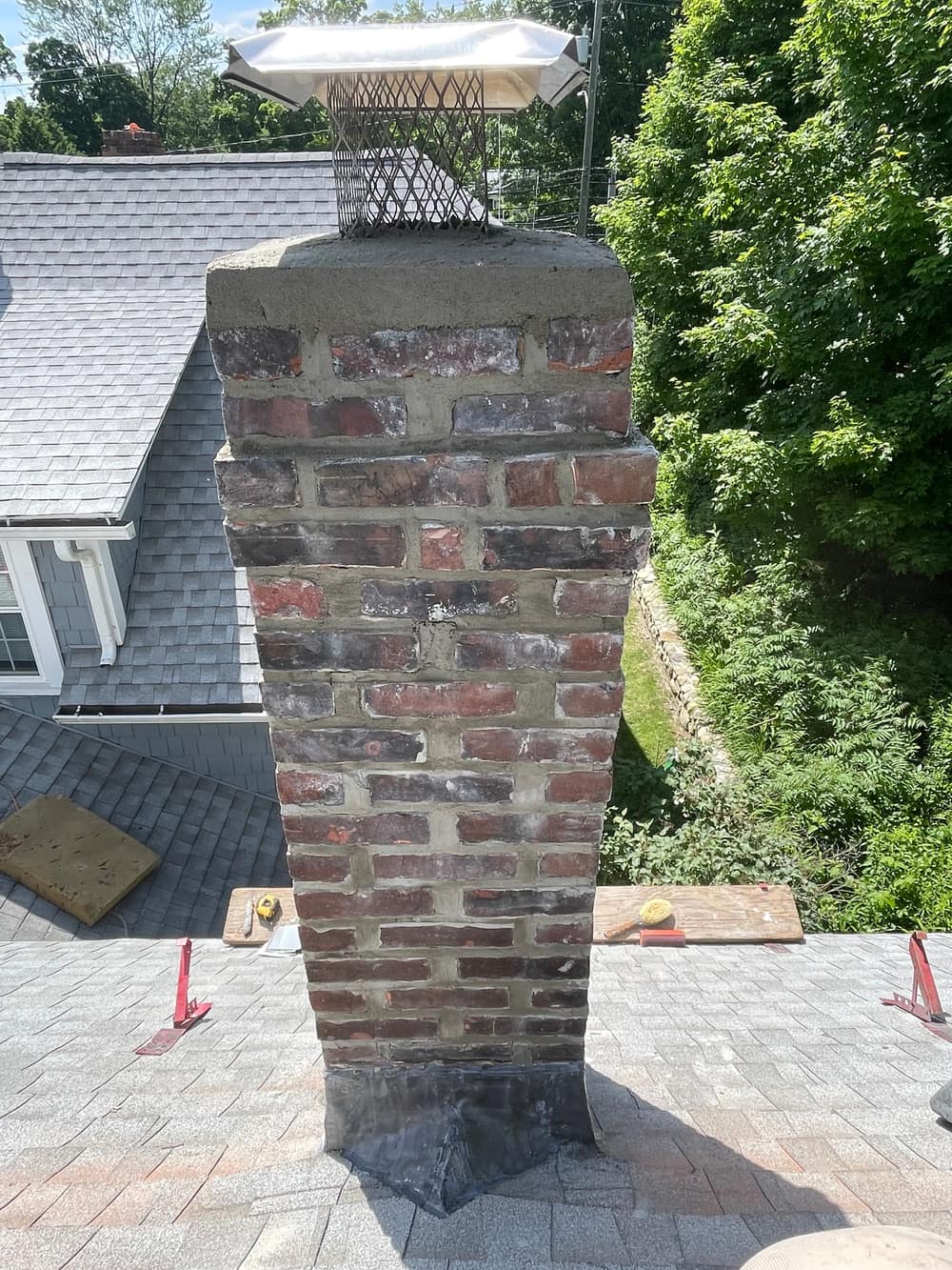 Curb appeal restored after full chimney restoration on a New England colonial